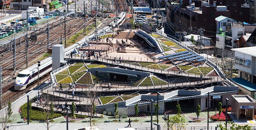 Oshiage Station Bicycle Parking Lot. This is a “water-friendly architecture”, which helps to suppress the heat island effect, and reduces load on sewage infrastructure, by reducing 100% of its rainwater drainage. It creates an urban cool spot where people can rest